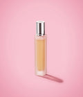 Huda Beauty Easy Bake Intense 10ml travel size perfume bottle on pink background