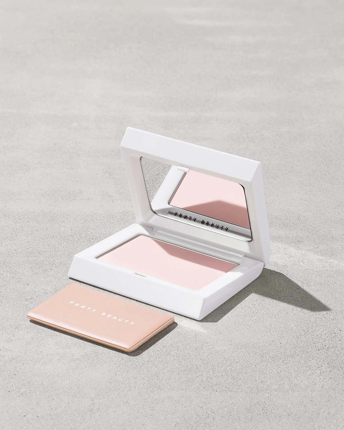 Fenty Beauty Bright Fix Powder in Rose Quartz compact.
