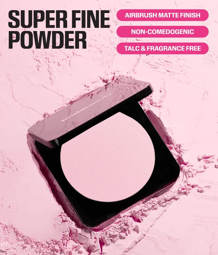 Huda Beauty Easy Bake Pressed Powder compact on crushed pink powder, with callouts: airbrush matte finish, non-comedogenic, talc and fragrance free
