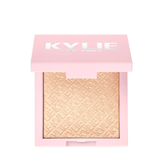 Kylie Cosmetics Kylighter illuminating powder highlighter in a light gold shade with a pink compact at ZARÉ Cosmetics