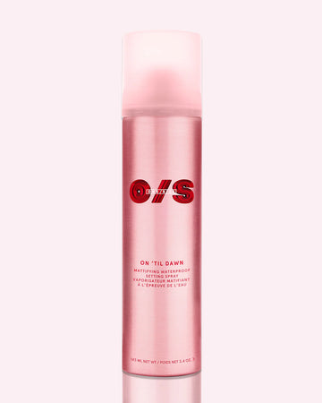 ONE/SIZE On ‘Til Dawn pink matte setting spray bottle with bold red branding, shown on glossy red background representing waterproof long-wear makeup lock and oil-control finish