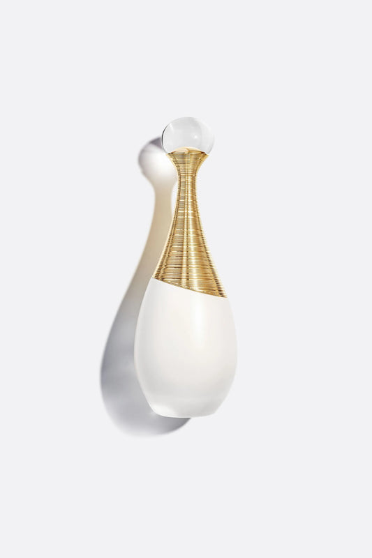Dior J'adore Parfum d'eau 100ml featuring an elegant opalescent white bottle with a gold neck design and crystal-like spherical cap against a light background.