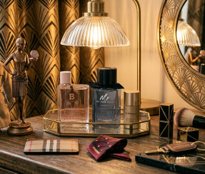Burberry Her and Mr. Burberry perfume bottles on a luxury vanity tray with aesthetic decor on ZARÉ Cosmetics