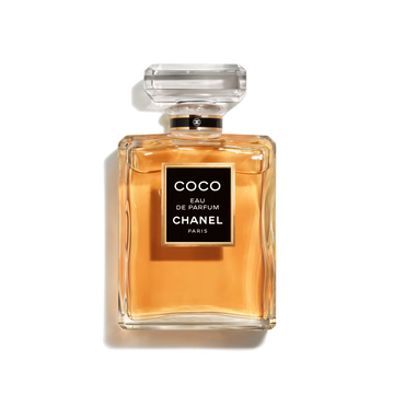 Chanel Coco Eau de Parfum 100ml fragrance bottle featuring a clear glass design, warm amber-colored perfume, black signature label, and transparent faceted cap against a black background.