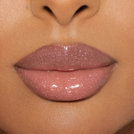 Kylie Cosmetics high gloss shimmery pink lip gloss lip swatch application on a model close-up at ZARÉ Cosmetics