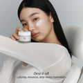 Beauty of Joseon Dynasty Cream glass jar on soft beige background showing minimal luxury Korean skincare packaging with clean aesthetic reflection.