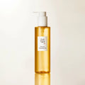 Close-up product shot of Beauty of Joseon Ginseng Cleansing Oil bottle with pump, minimal studio lighting and soft reflection base.