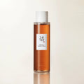 Close-up skincare product shot of Ginseng Essence Water bottle reflecting clean Korean herbal skincare aesthetic.