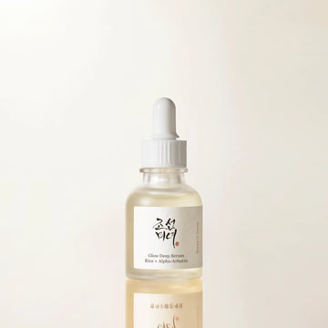 Product bottle of Beauty of Joseon Glow Deep Serum Rice + Alpha-Arbutin with minimal studio lighting and soft reflection surface.