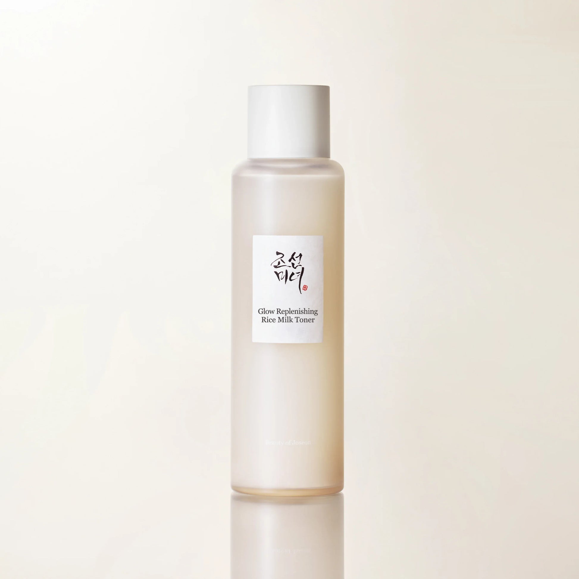 Close-up product shot emphasizing hydrating rice toner with warm beige minimal skincare branding and water splash base.