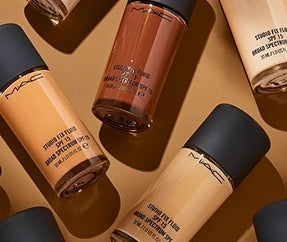 MAC Studio Fix Fluid SPF 15 foundation bottles showcasing multiple liquid shades on ZARÉ Cosmetics