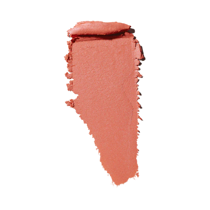 MAC Glow Play creamy blush or lip product texture swatch in a coral pink shade isolated on white at ZARÉ Cosmetics