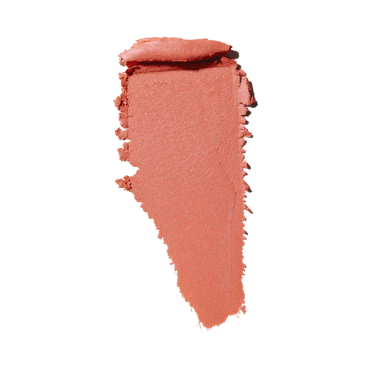 MAC Glow Play creamy blush or lip product texture swatch in a coral pink shade isolated on white at ZARÉ Cosmetics