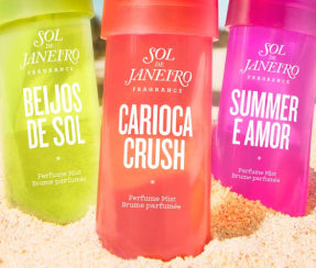 Sol de Janeiro perfume mists Beijos de Sol, Carioca Crush, and Summer e Amor on beach sand at ZARÉ Cosmetics