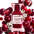 Tom Ford Electric Cherry Eau De Parfum 50ml bottle surrounded by fresh cherries and white flowers at ZARÉ Cosmetics
