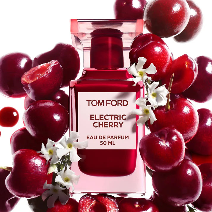 Tom Ford Electric Cherry Eau De Parfum 50ml bottle surrounded by fresh cherries and white flowers at ZARÉ Cosmetics